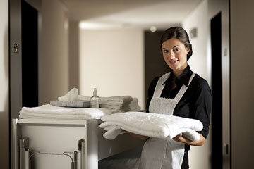 hotel maid doing housekeeping chores